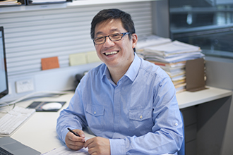 David Huang in office smiling