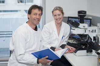 Associate Professor Matthias Ernst and Dr Tracy Putoczki in a laboratory