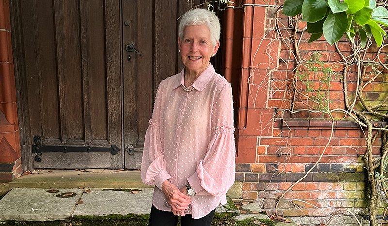 Myrna wearing a pink blouse